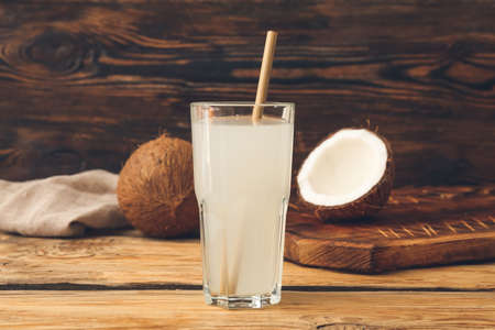 Glass of fresh coconut water on tableの写真素材