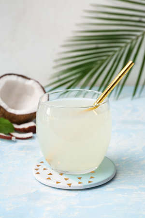 Glass of fresh coconut water on tableの写真素材