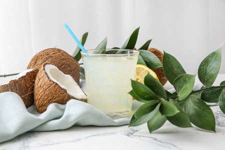 Glass of fresh coconut water on tableの写真素材
