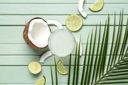 Composition with fresh coconut water on wooden backgroundの写真素材