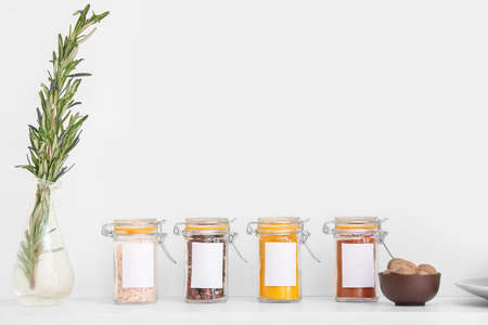 Jars with different spices on table in kitchenの写真素材