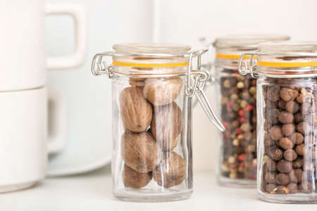Jars with different spices on light background, closeupの写真素材