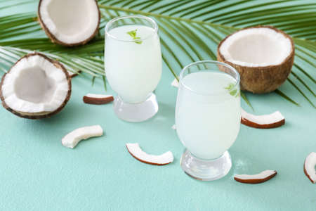 Composition with fresh coconut water on color backgroundの写真素材
