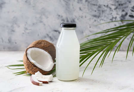 Bottle of fresh coconut water on tableの写真素材