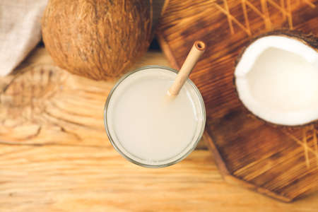 Glass of fresh coconut water on tableの写真素材