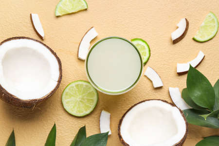 Composition with fresh coconut water on color backgroundの写真素材