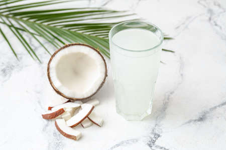 Glass of fresh coconut water on tableの写真素材