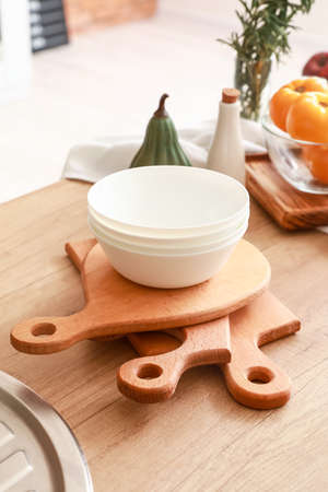 Cutting boards and bowls on kitchen tableの写真素材