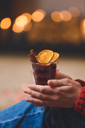 Woman with tasty mulled wine at home on Christmas eveの写真素材