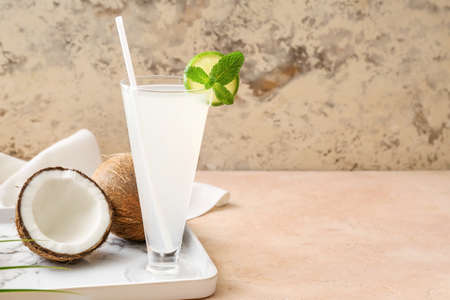 Glass of fresh coconut water on table