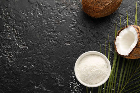 Bowl with coconut flakes on dark backgroundの写真素材