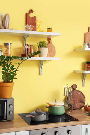 Cooking pots on electric stove in modern kitchenの写真素材