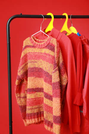 Rack with stylish clothes on color backgroundの写真素材