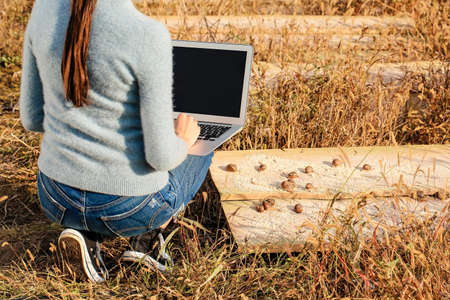 Worker with laptop at snail farmの写真素材