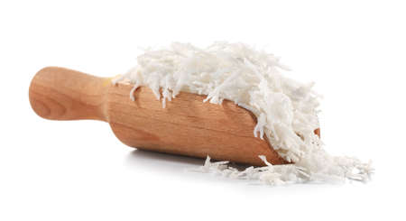 Scoop with coconut flakes on white backgroundの写真素材