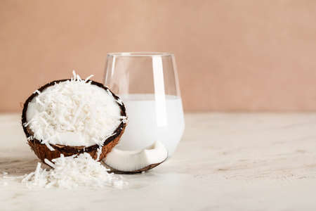 Coconut with flakes on light tableの写真素材
