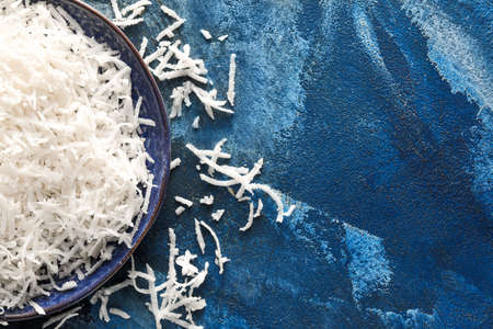 Plate with coconut flakes on color backgroundの写真素材