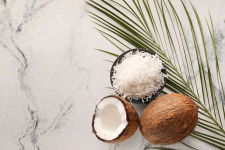 Bowl with coconut flakes on light backgroundの写真素材