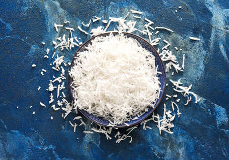 Plate with coconut flakes on color backgroundの写真素材
