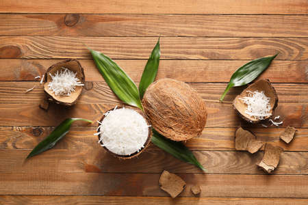 Coconut with flakes on wooden backgroundの写真素材