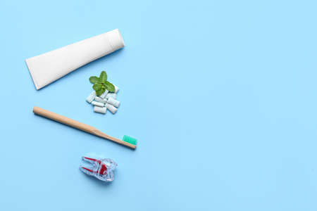 Chewing gums, toothbrush and paste on color backgroundの写真素材