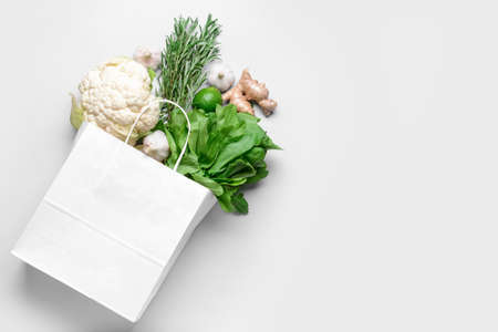 Paper bag with different products on light backgroundの写真素材