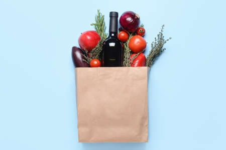 Paper bag with different products on color backgroundの写真素材