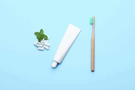 Chewing gums, toothbrush and paste on color backgroundの写真素材