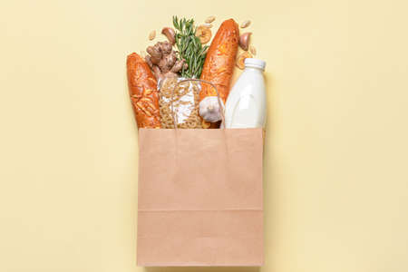 Paper bag with different products on color backgroundの写真素材
