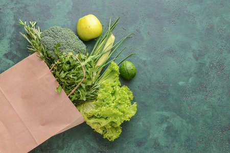 Paper bag with different products on color backgroundの写真素材