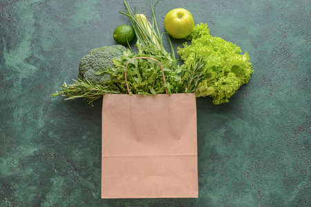 Paper bag with different products on color backgroundの写真素材