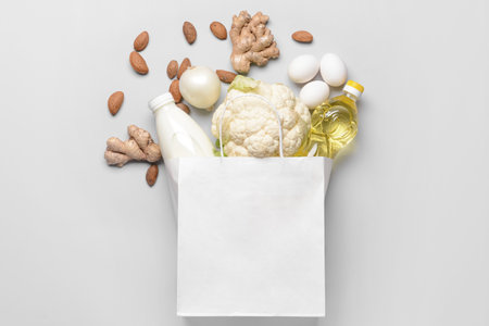 Paper bag with different products on light backgroundの写真素材