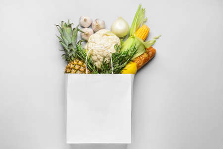 Paper bag with different products on light backgroundの写真素材