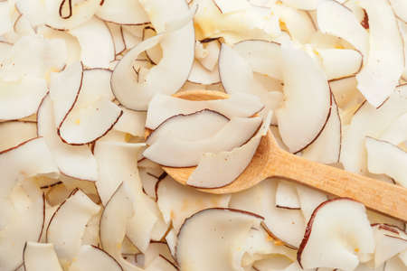 Spoon with tasty coconut chips, closeupの写真素材