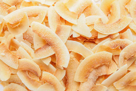Tasty coconut chips as backgroundの写真素材