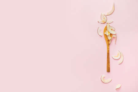 Spoon with tasty coconut chips on color backgroundの写真素材