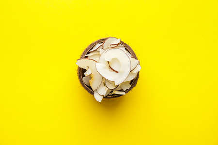 Coconut with tasty chips on color backgroundの写真素材