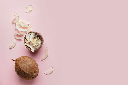 Coconut with tasty chips on color backgroundの写真素材
