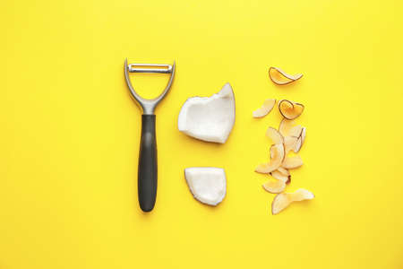 Tasty coconut chips and slicer on color backgroundの写真素材