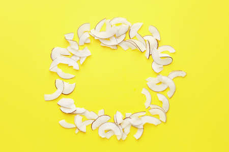 Frame made of tasty coconut chips on color backgroundの写真素材