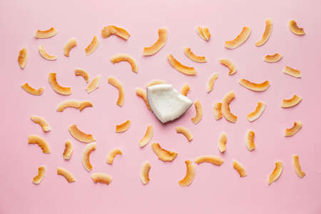 Tasty coconut chips on color backgroundの写真素材