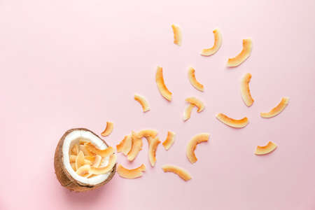 Tasty coconut chips on color backgroundの写真素材