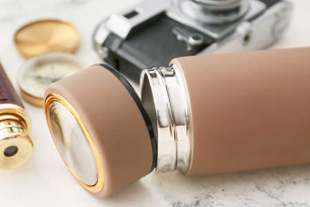 Modern flask and items for travel on light backgroundの写真素材