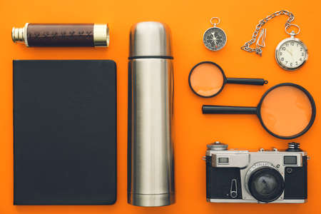 Modern flask and items for travel on color backgroundの写真素材