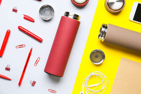 Modern flask and stationery on color backgroundの写真素材