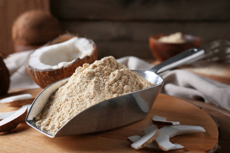Scoop with coconut flour on wooden backgroundの写真素材