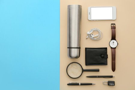 Modern flask and items for travel on color backgroundの写真素材
