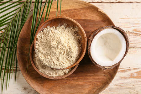 Bowls with coconut flour on wooden backgroundの写真素材
