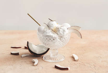 Bowl with tasty coconut ice cream on color backgroundの写真素材