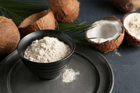 Bowl with coconut flour on dark backgroundの写真素材